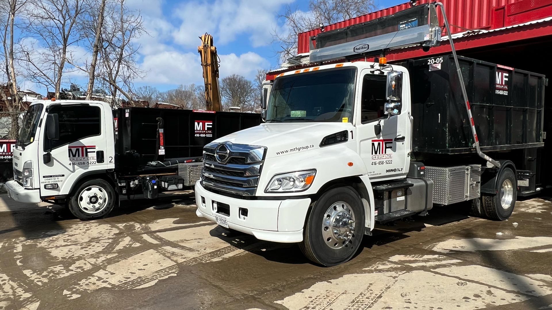 2 of MTF trucks parked with