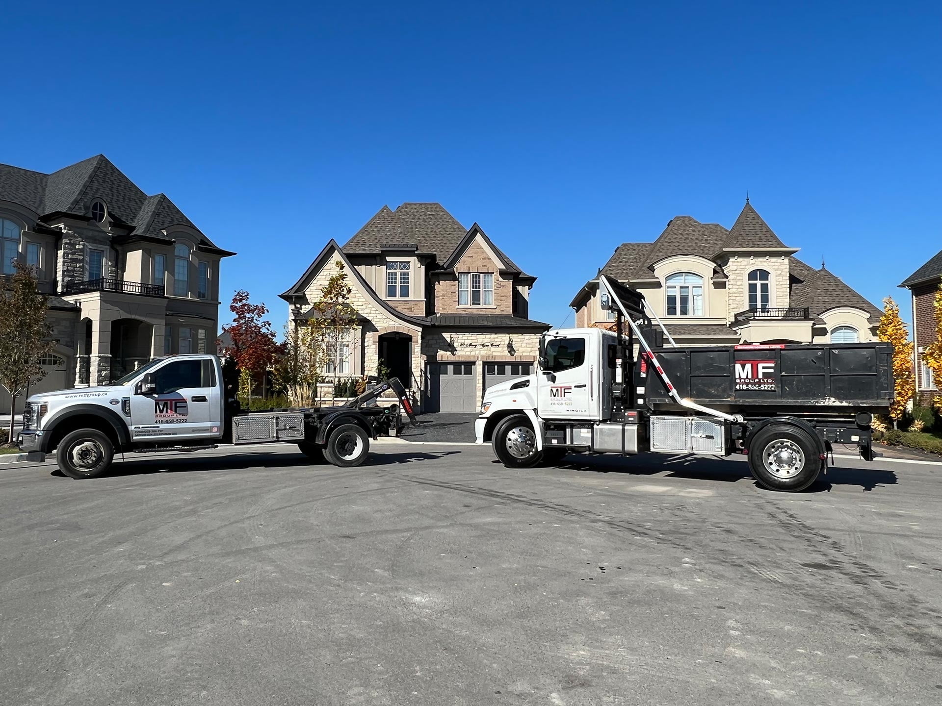 MTF Group garbage bin rental trucks outside of a residential area