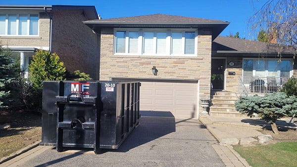 20 yard garbage bin rental in a residential driveway