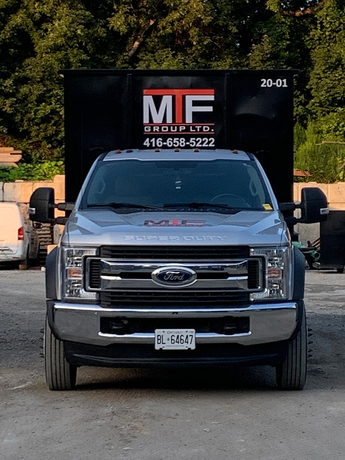 forward facing MTF truck with a garbage bin rental loaded